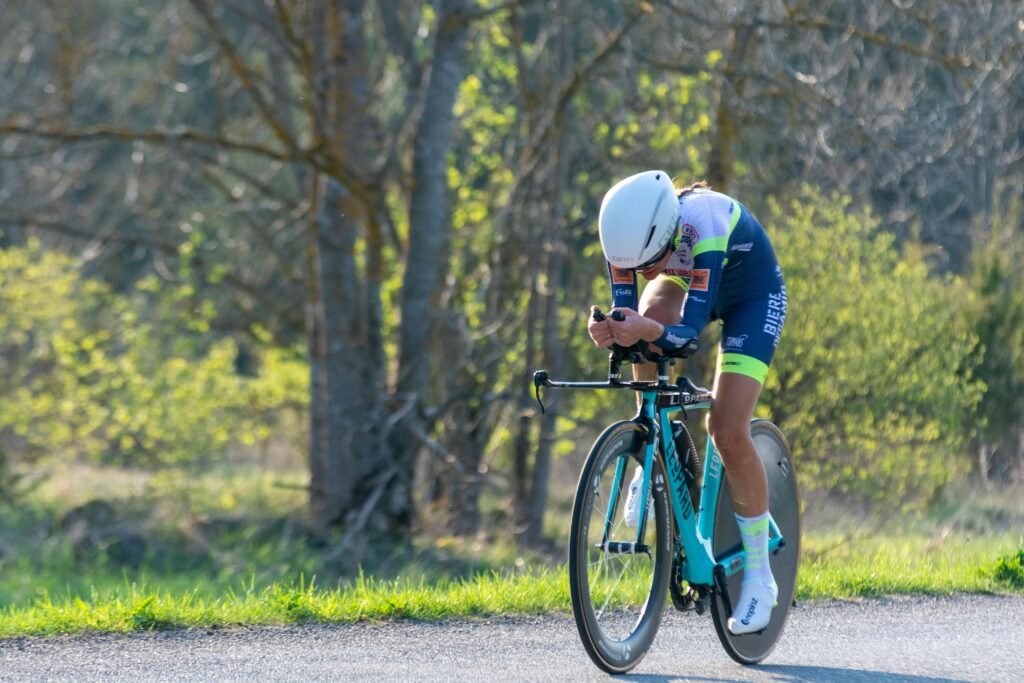 A determined cyclist racing through a scenic spring landscape. Perfect for sports themes.
