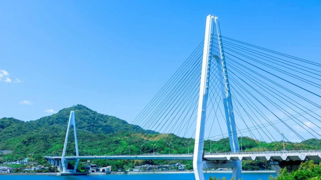 Explore the stunning Tatara Bridge against a vibrant, clear blue sky in Hiroshima, Japan.