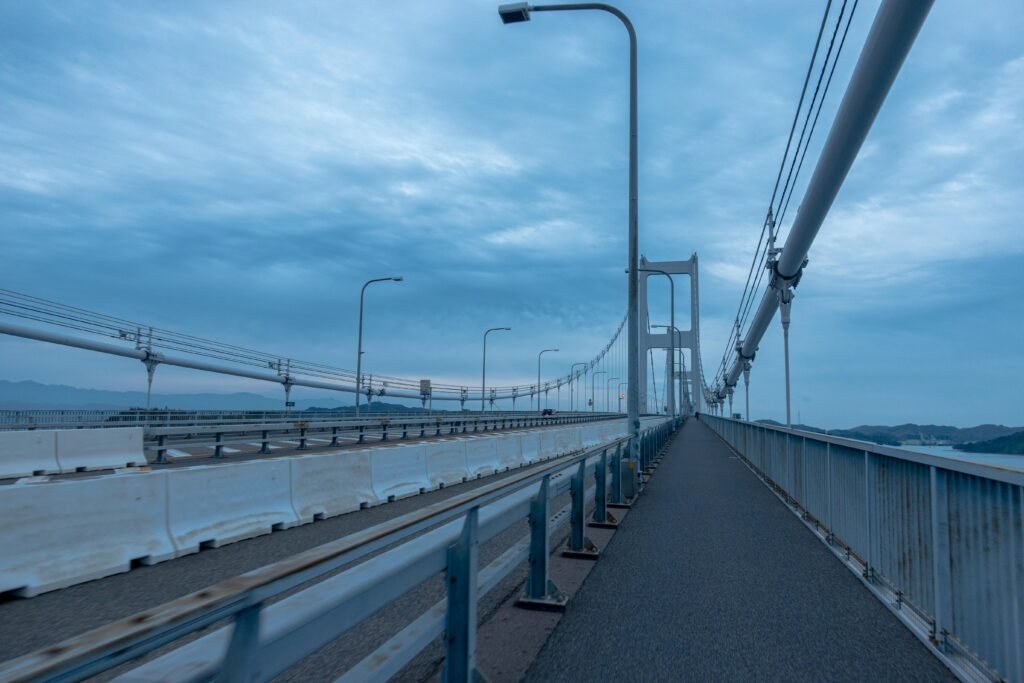 Scenic view of a suspension bridge in Onomichi, Japan under cloudy skies.